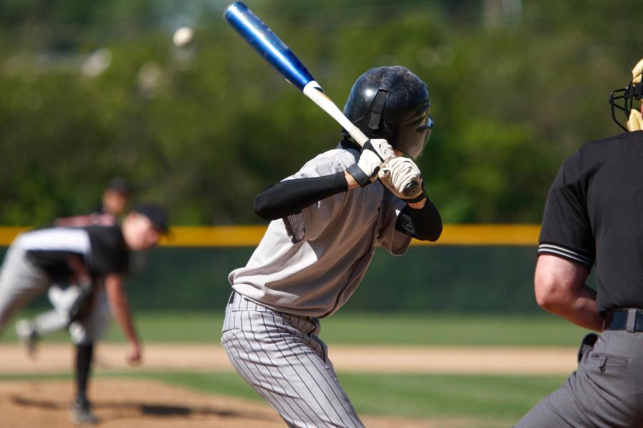 A baseball player prepares to swing