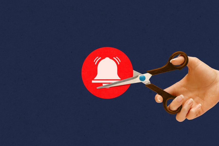 illustration of a hand holding a pair of scissors cutting a notification bell icon