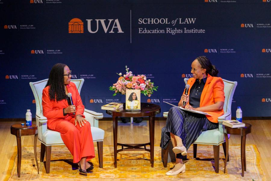 Supreme Court Justice Ketanji Brown Jackson and Kimberly Jenkins Robinson sitting on a stage at the UVA School of Law discussing Jackson's book