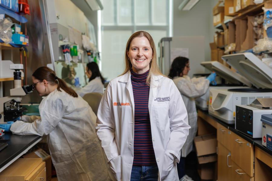 Kristin Anderson standing in her laboratory at UVA in front of her research assistants.