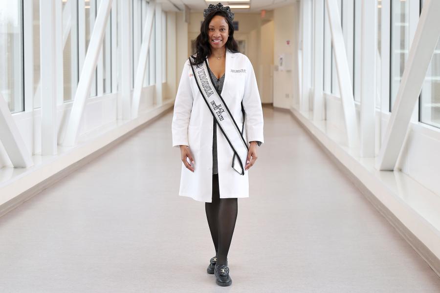 Marquita Taylor in her lab coat and show sash and tiara