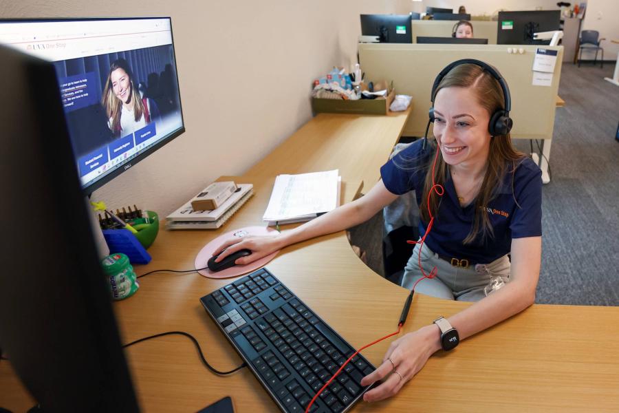 A student working at a computer help desk