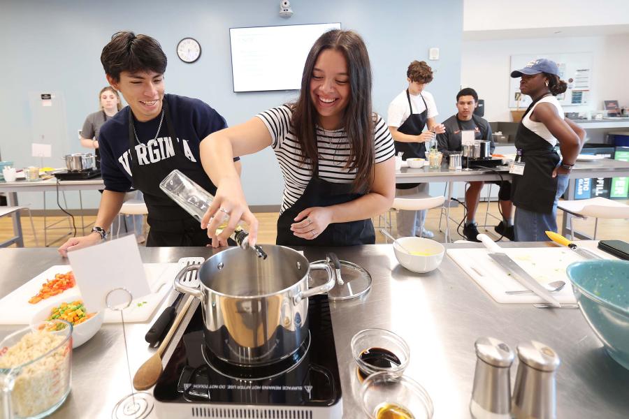 Diego Chavez and Jenny Mejia cooking in the UVA teaching kitchen.