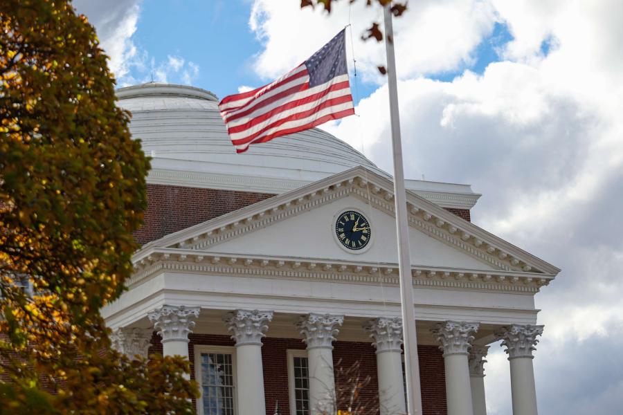 front entrance of the UVA Rotunda on an overcast afternoon with a flagpole in the foreground