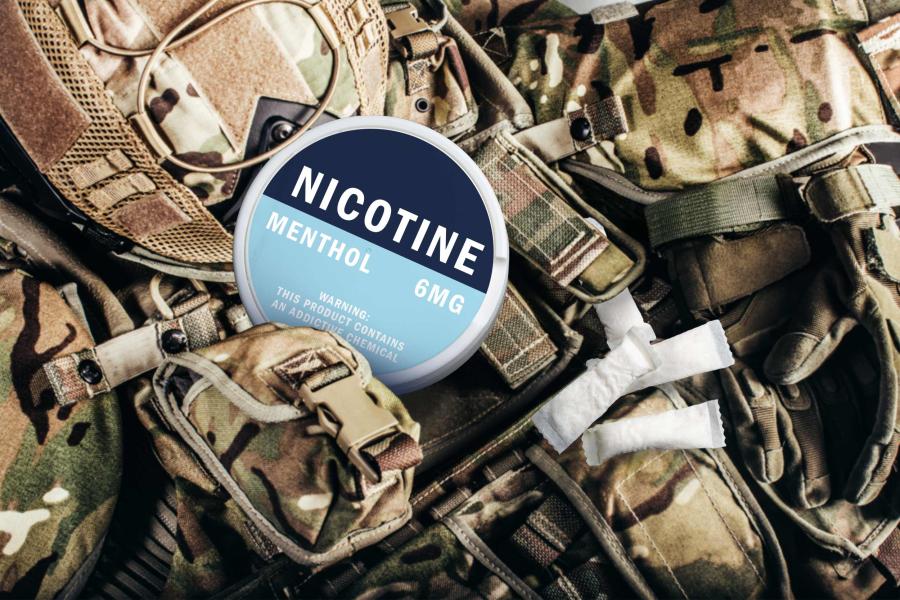 A nicotine tin buried among an Army uniform