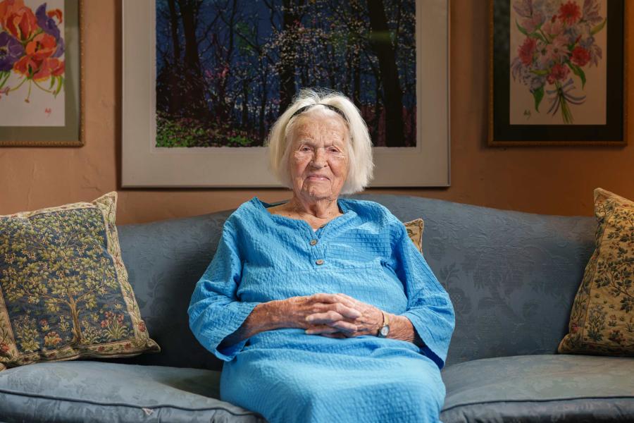 portrait of Virginia Stokes sitting on her couch in her living room