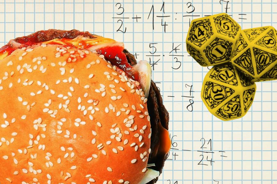 A hamburger and three ornate dice on a piece of graph paper with math problems involving fractions written on it