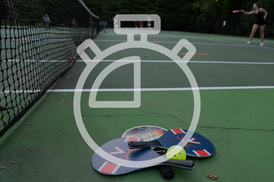 Pickleball court overlaid with an illustration of a stopwatch