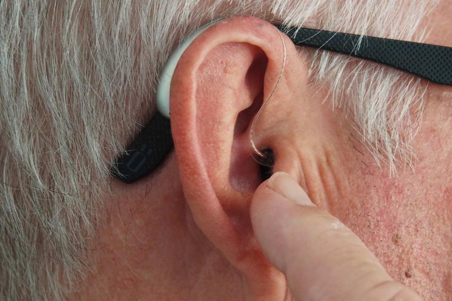 Up close of a man wearing a hearing aid