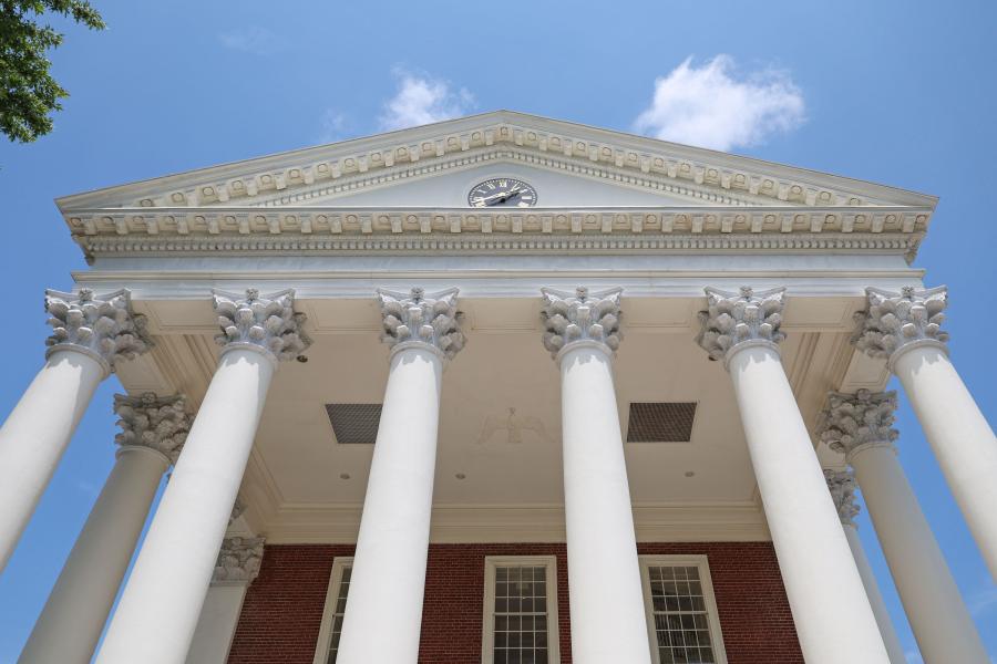 looking up at the capitals of the columns on the Rotunda building on a clear afternoon