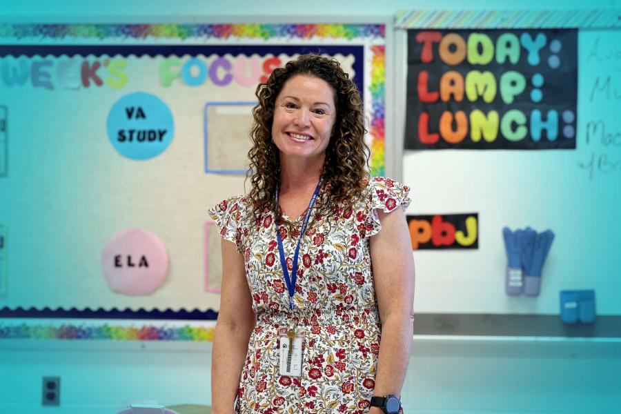 Portrait of Anne Duckworth standing in her classroom.