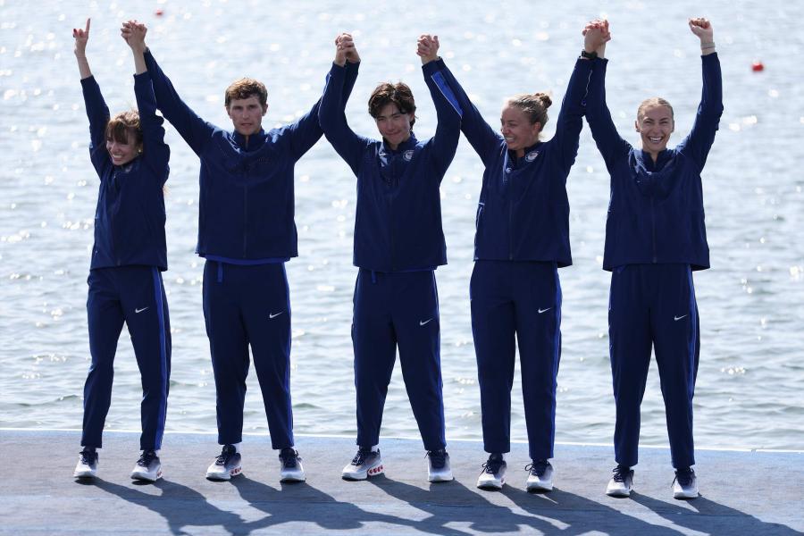 A group portrait of the US Paralympics rowing team celebrating their silver medal win, including UVA student rower Skylar Dahl on the far right.