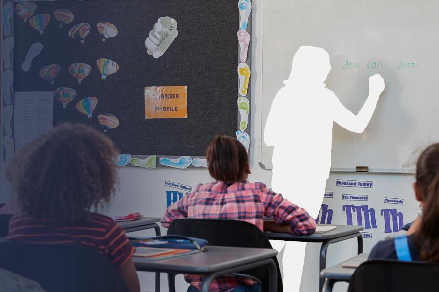 A graphic of a missing, whited out teacher writing on a whiteboard in front of students