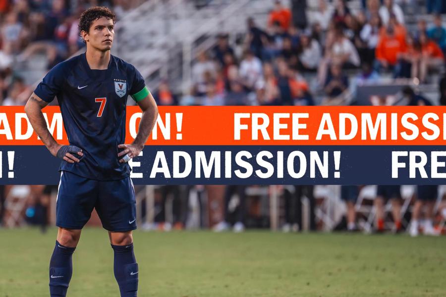 UVA men's soccer player standing on the field with a banner behind him that reads ”Free Admission“