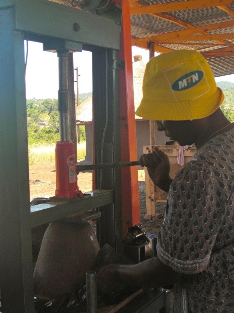 A member of the Mukondeni Pottery Cooperative pressing water filters