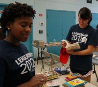 Chelsea Stokes (left) and Mary Kidd sort books at the Westhaven public housing project. 
