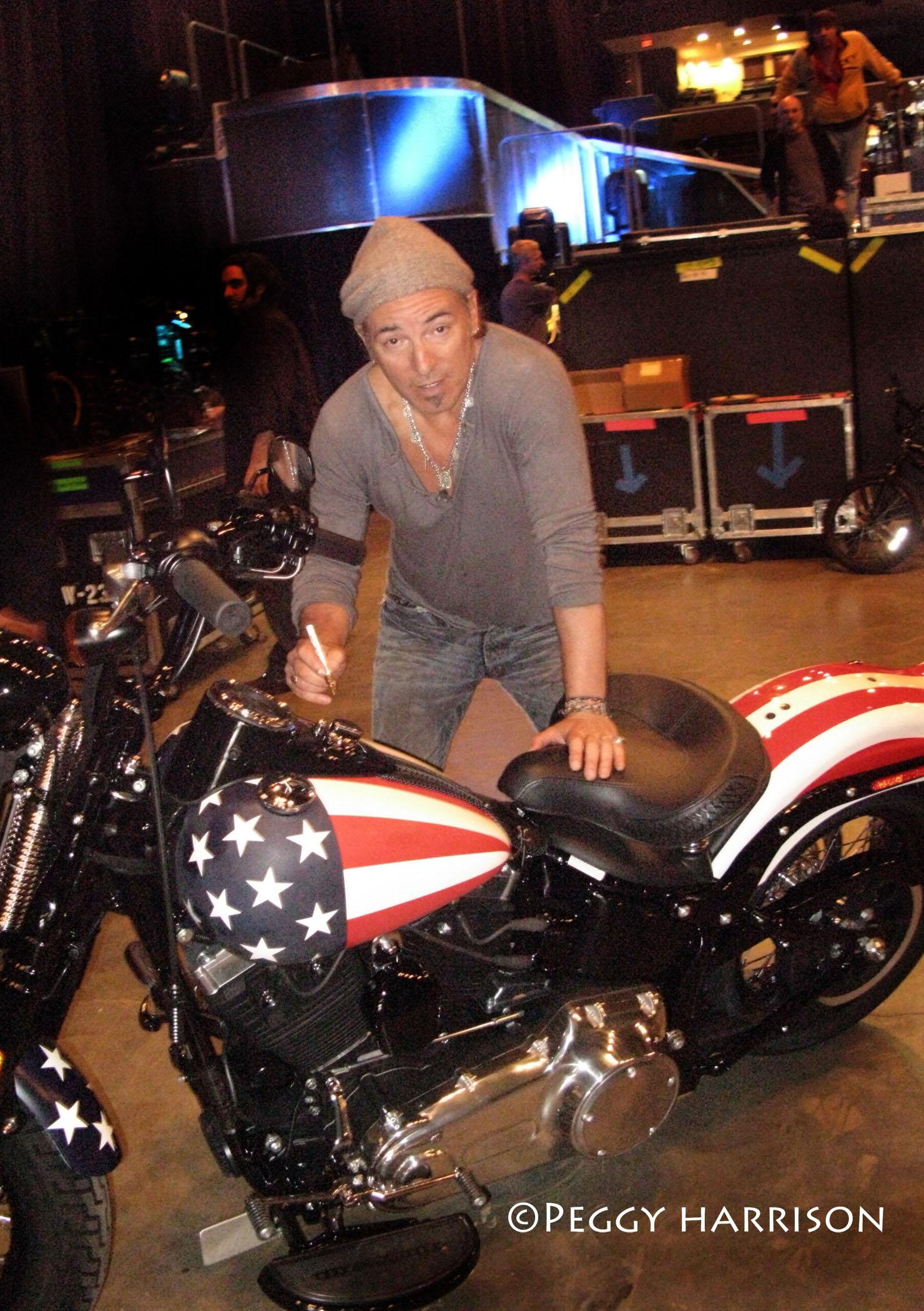 Bruce Springsteen signs the 2008 Harley-Davidson Cross Bones motorcycle.(Photo: Peggy Harrison)