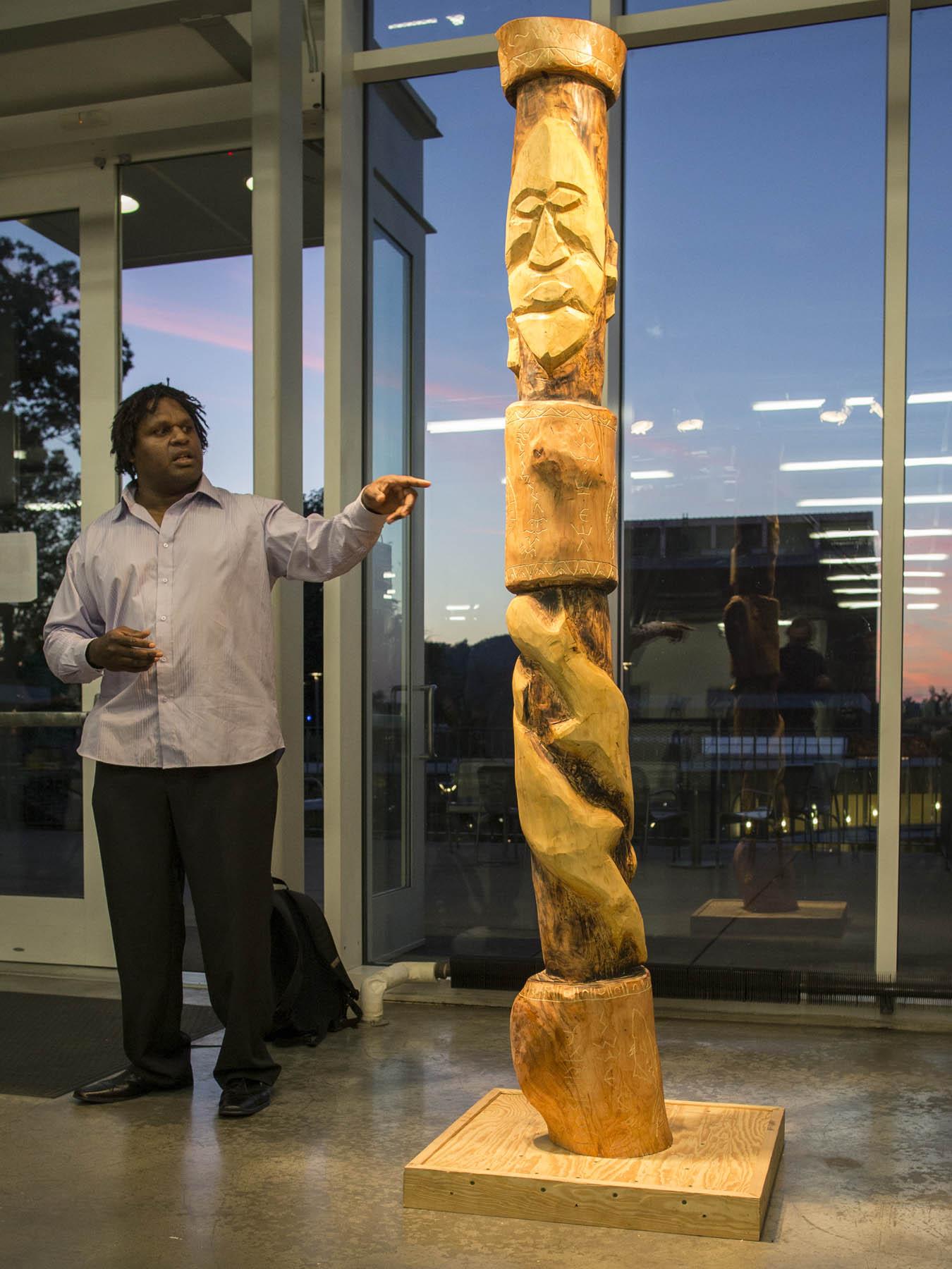 Bosun celebrates the totem pole he worked on with U.Va. students during his residency.
