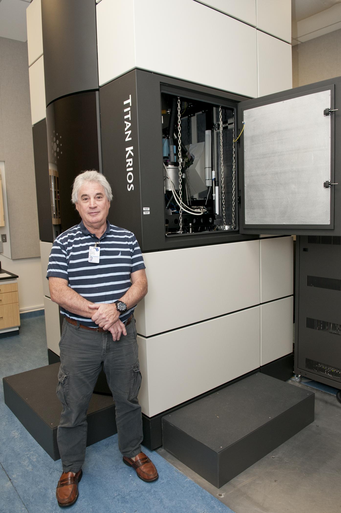 Edward H. Egelman with the massive Titan Krios microscope that’s buried in tons of concrete under Fontaine Research Park.