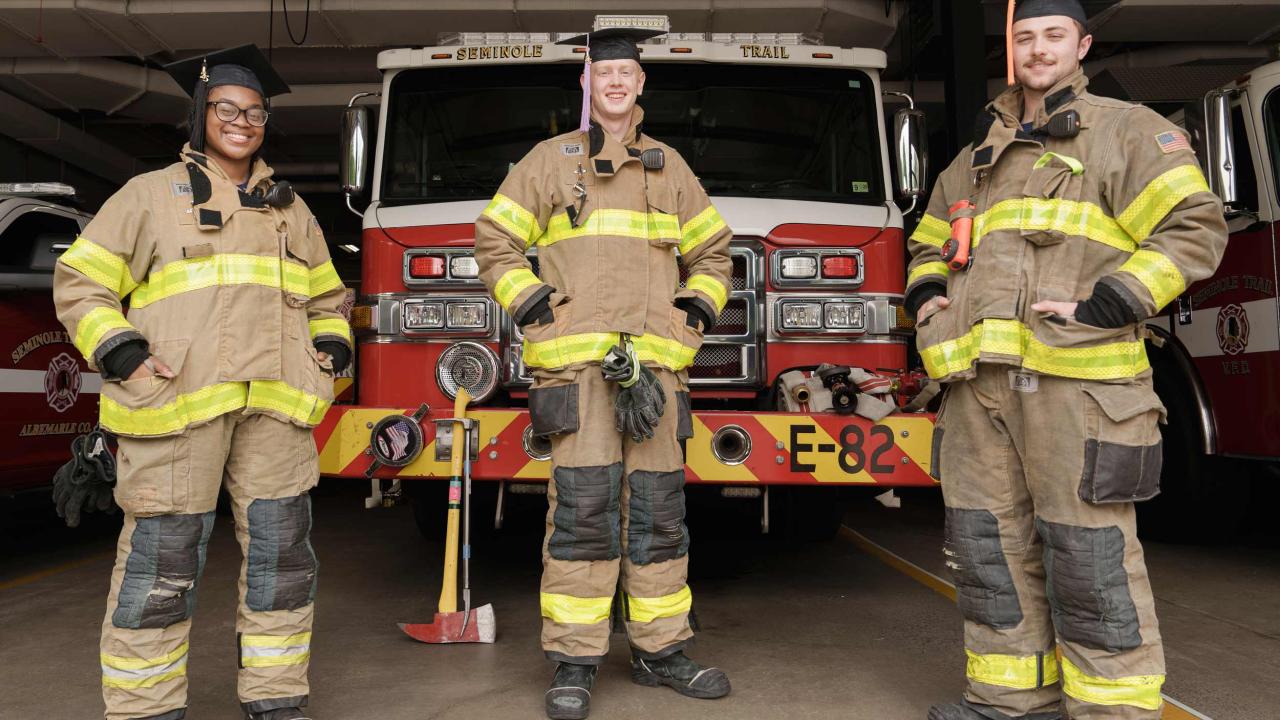 Portrait of UVA Graduate from left Takelia Jones, Kevin Holcombe and Mannix Green in fire fighter uniform.