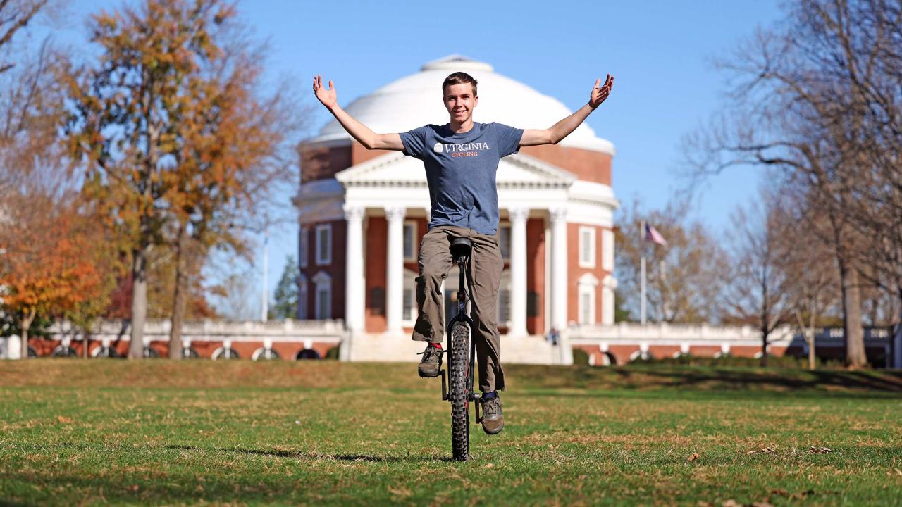 Mason Allen on his unicycle in front of the Rotunda on the Lawn