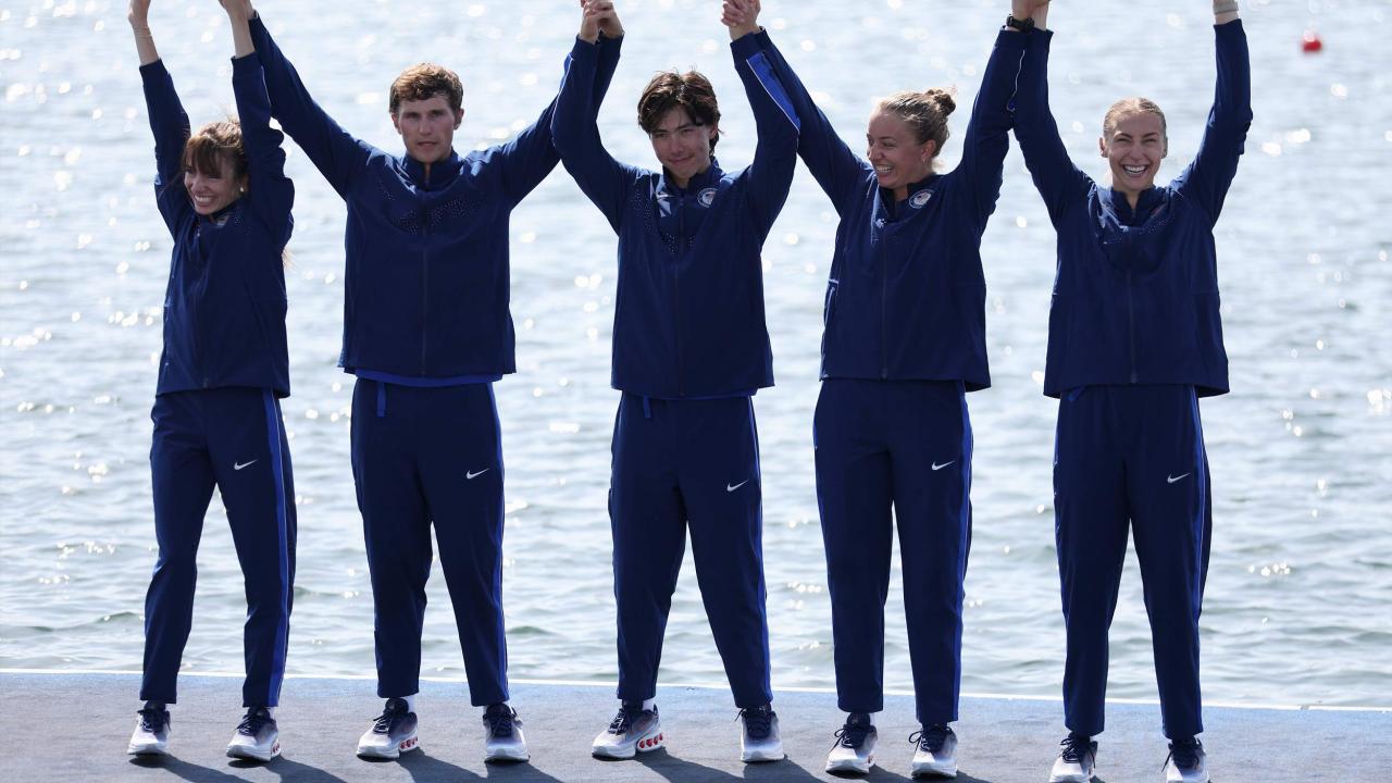 A group portrait of the US Paralympics rowing team celebrating their silver medal win, including UVA student rower Skylar Dahl on the far right.