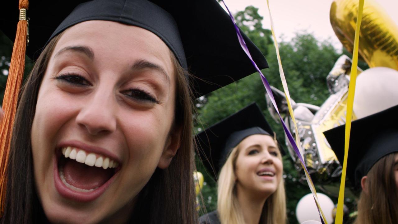  Happy graduates smile while taking a selfie