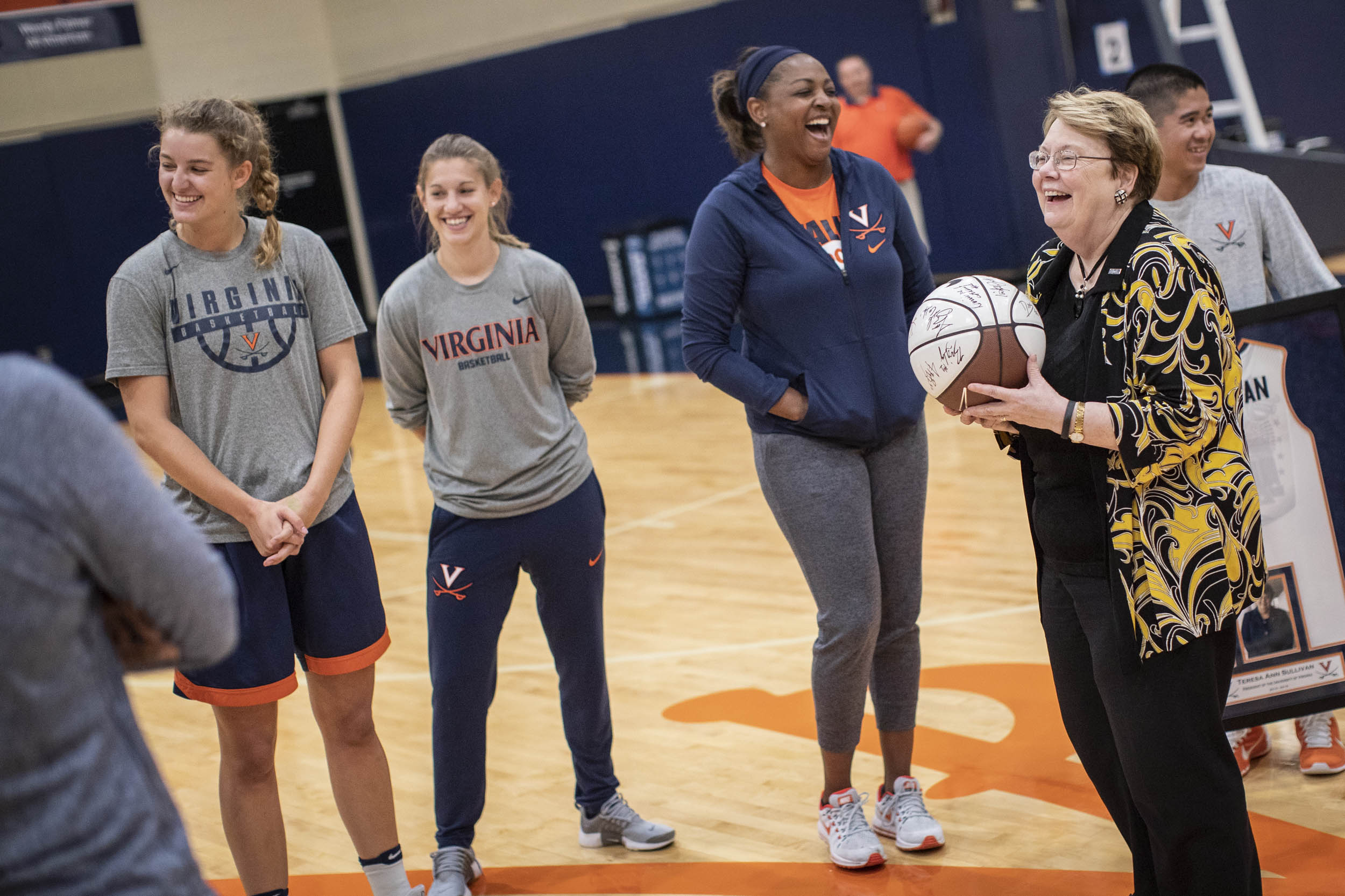 President Sullivan holds a UVA Womens basketball team signed bsketball
