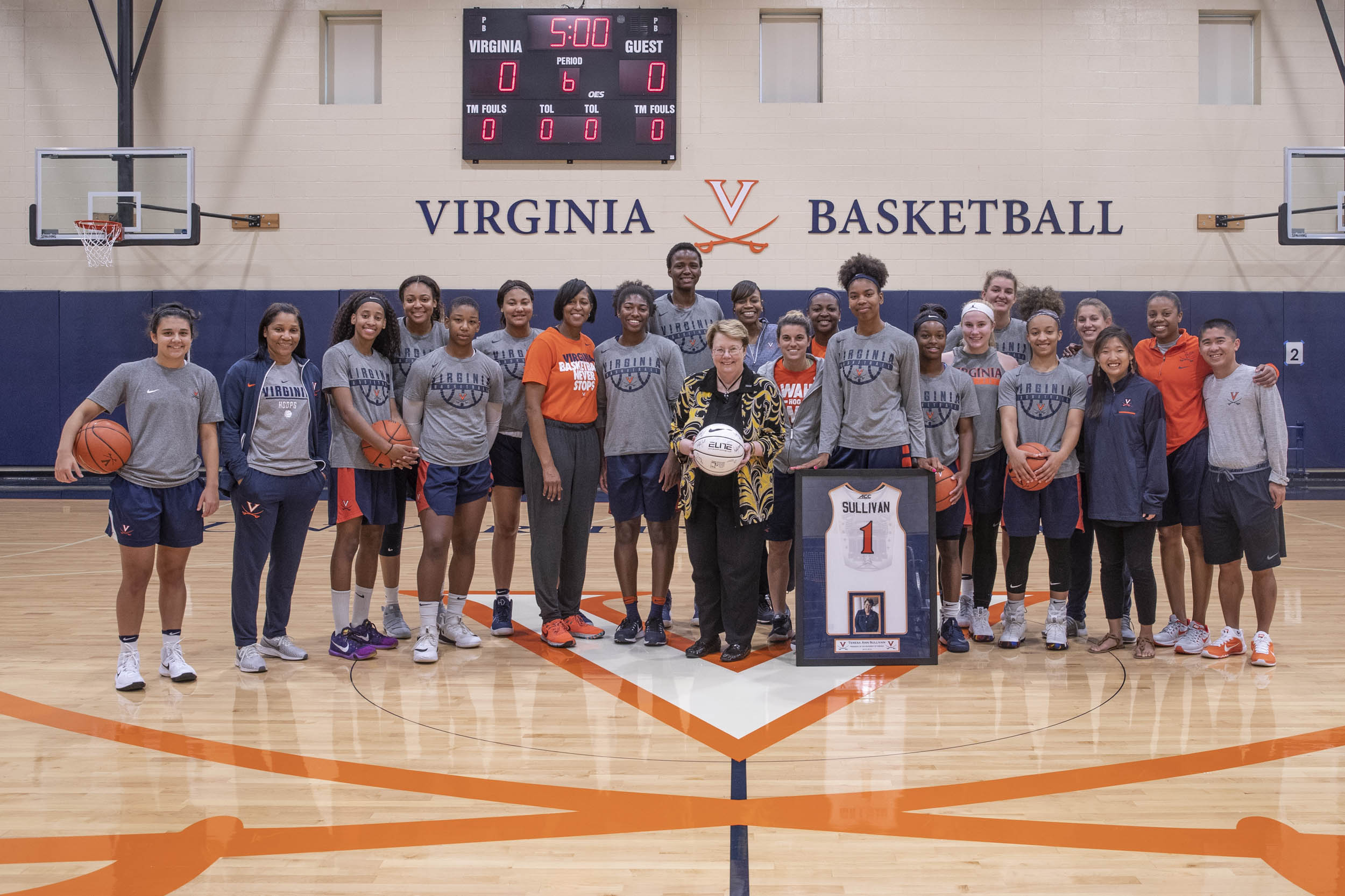 President Sullivan stands for a group photo with the Womens basketball team