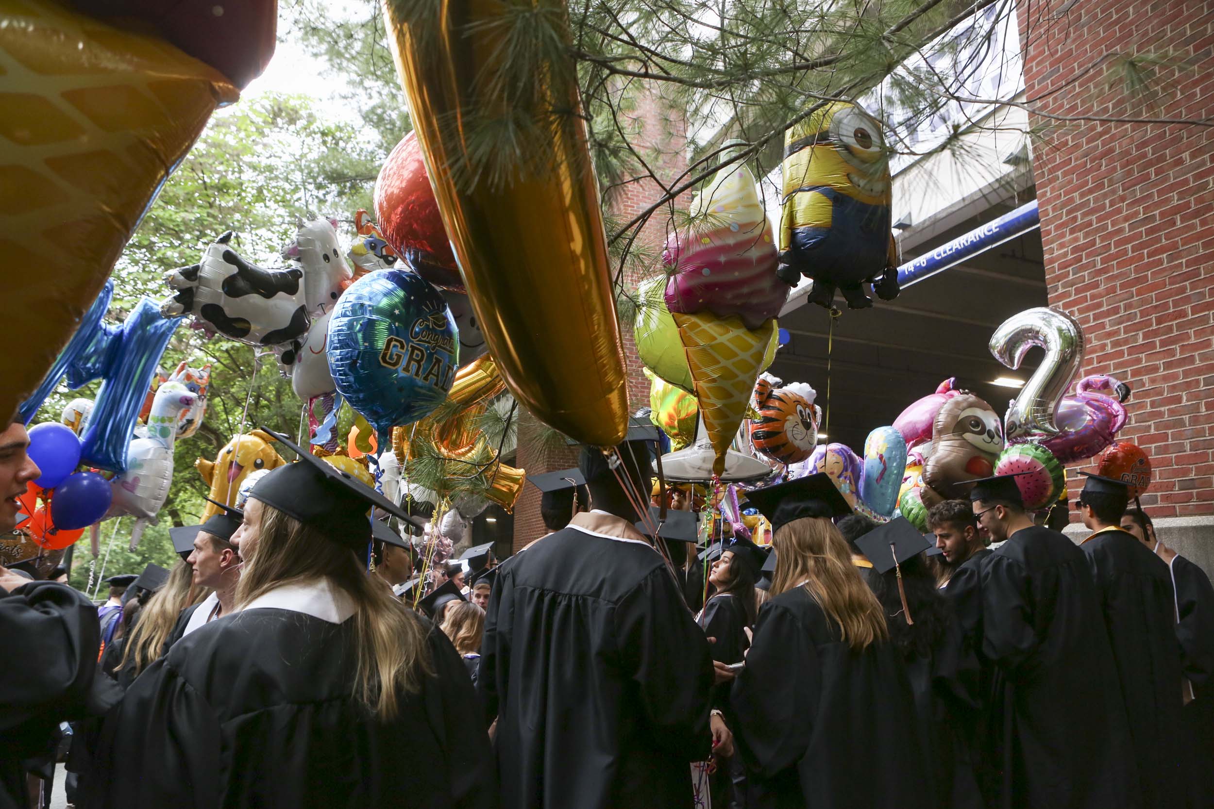 Graduates standing with balloons 