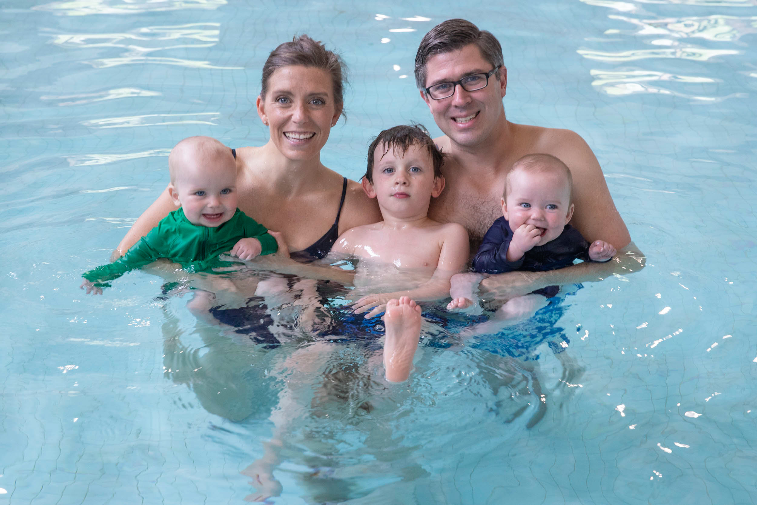 The Greenwoods pose together in the water with their three children