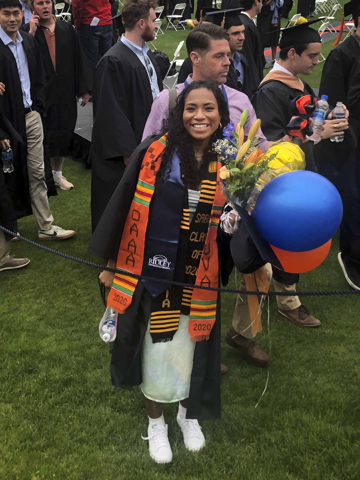 Sydney Willams posing for a picture in her gown and holding balloons