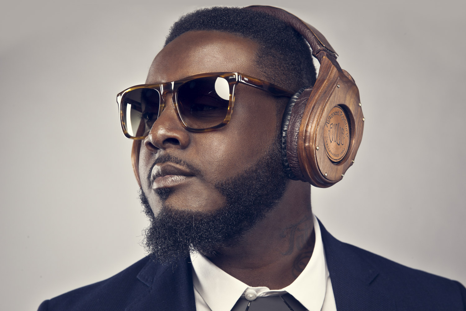 T-Pain wearing wooden headphones and sunglasses looks away from the camera