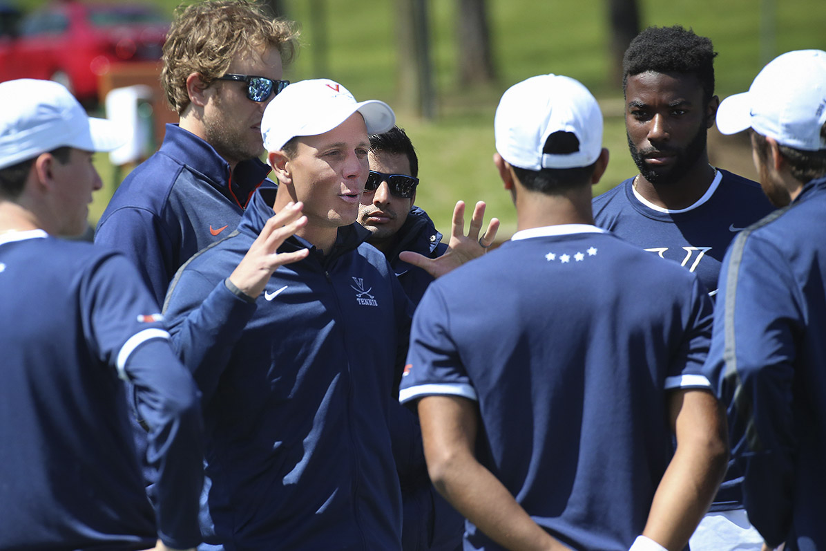 Andres Pedroso speaks to the mens tennis team as they are huddled up