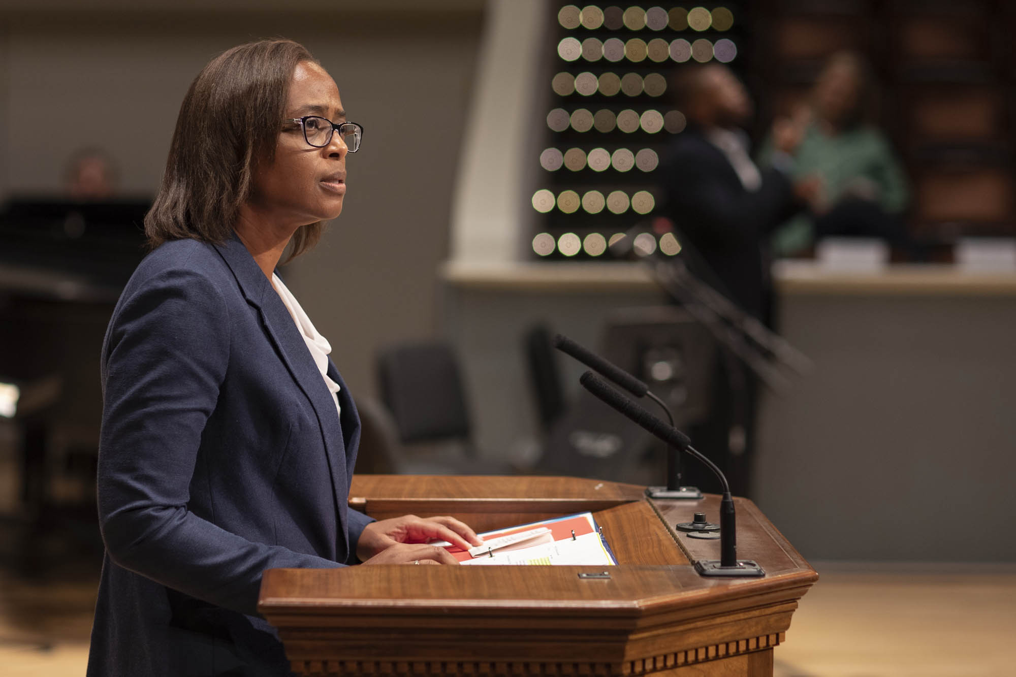 Carla Williams standing at a podium speaking to a crowd