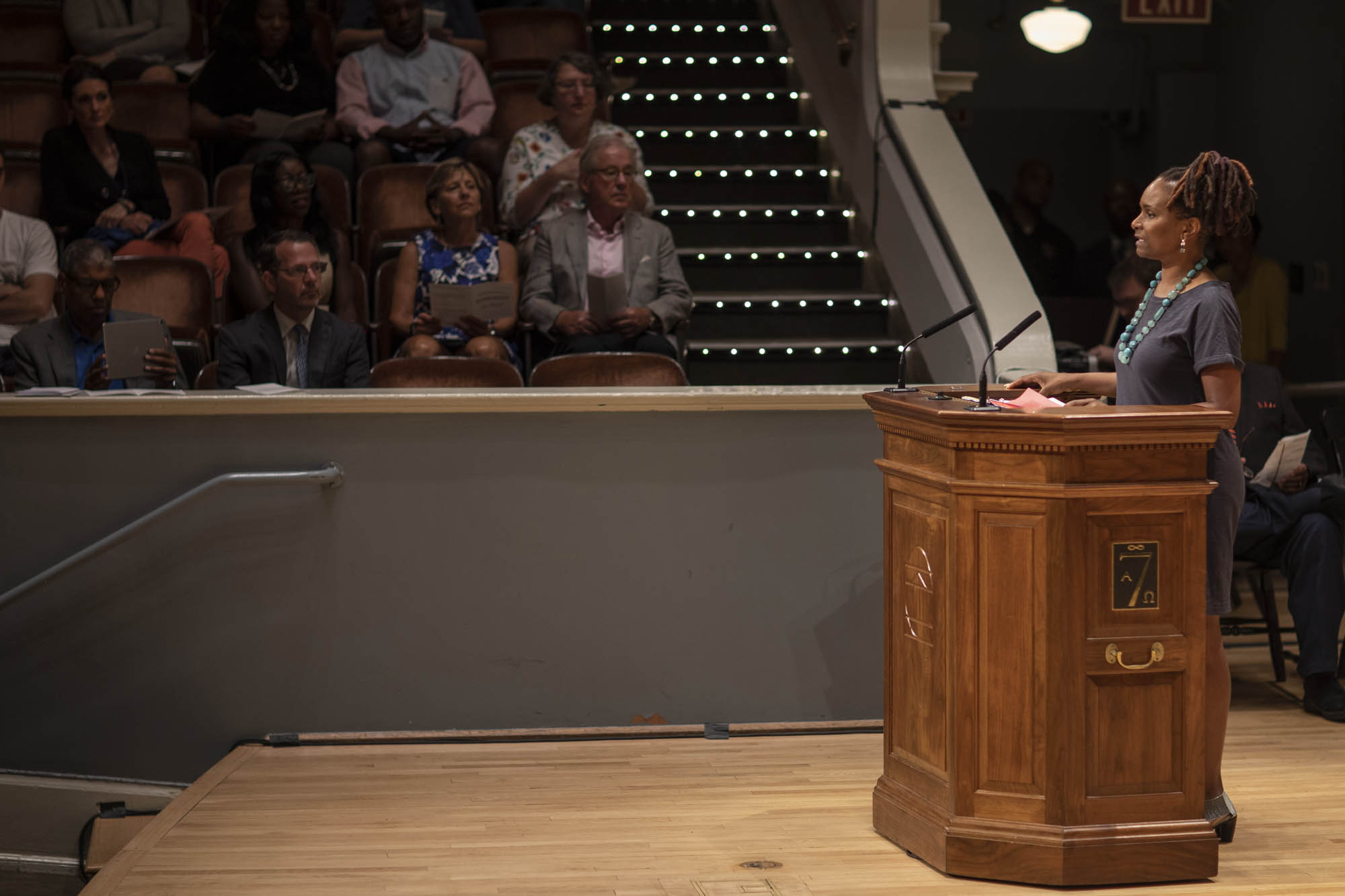 Valencia Robin standing at a podium giving a speech to a crowd