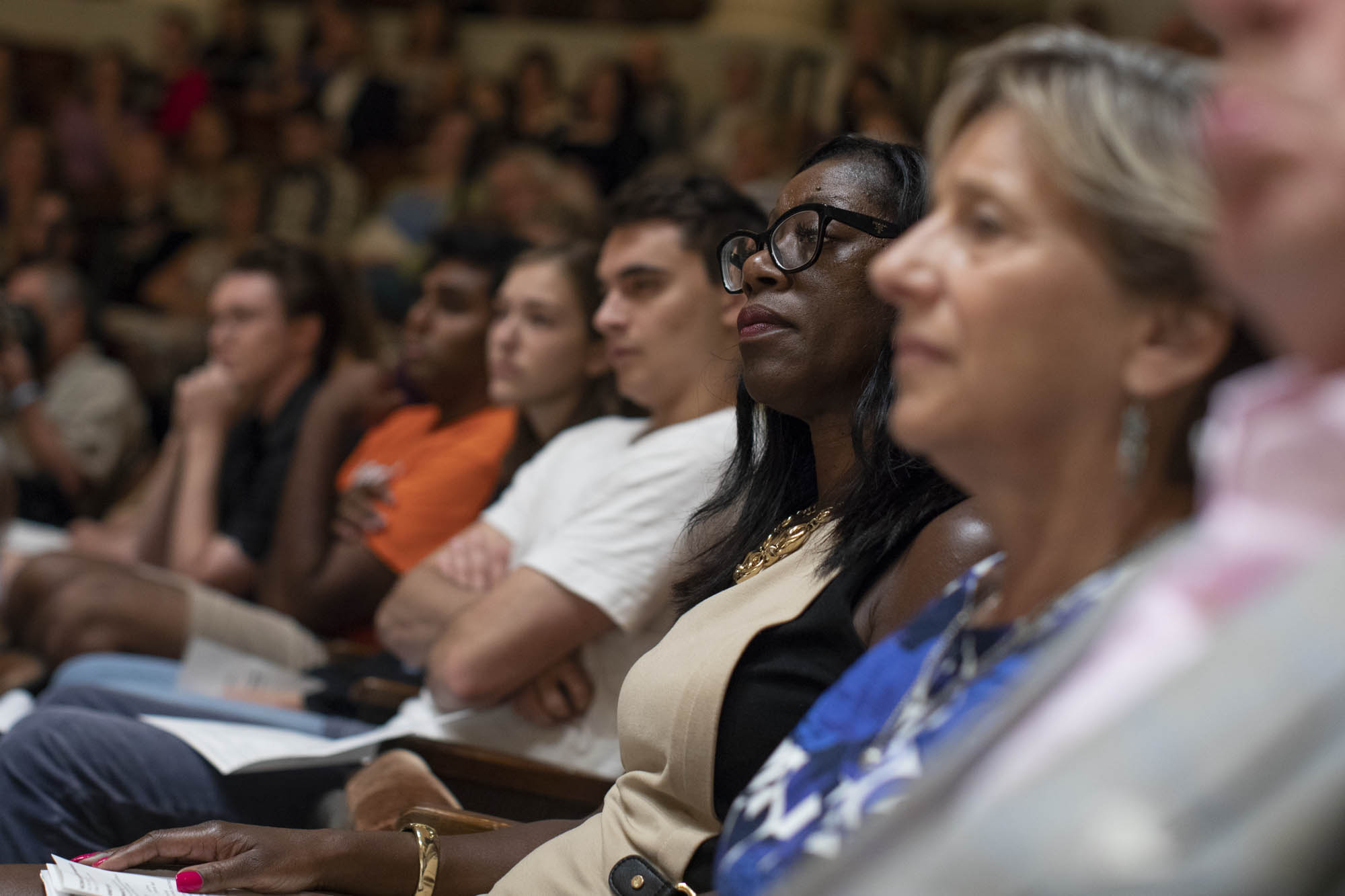 up close view of a crowd listening to the speaker