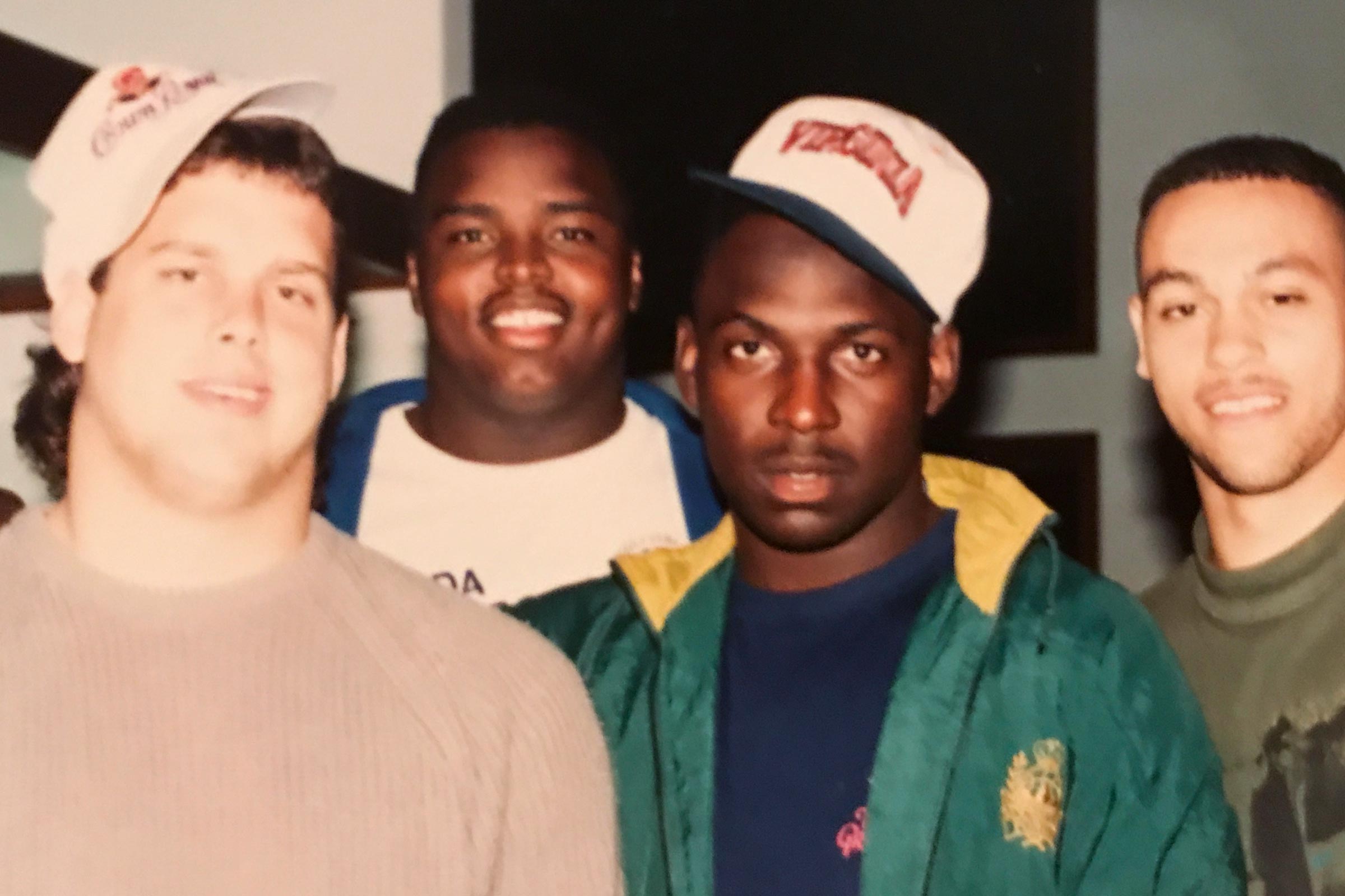 Roberts, second from left,  Shawn Moore, second from right pose with fellow football players