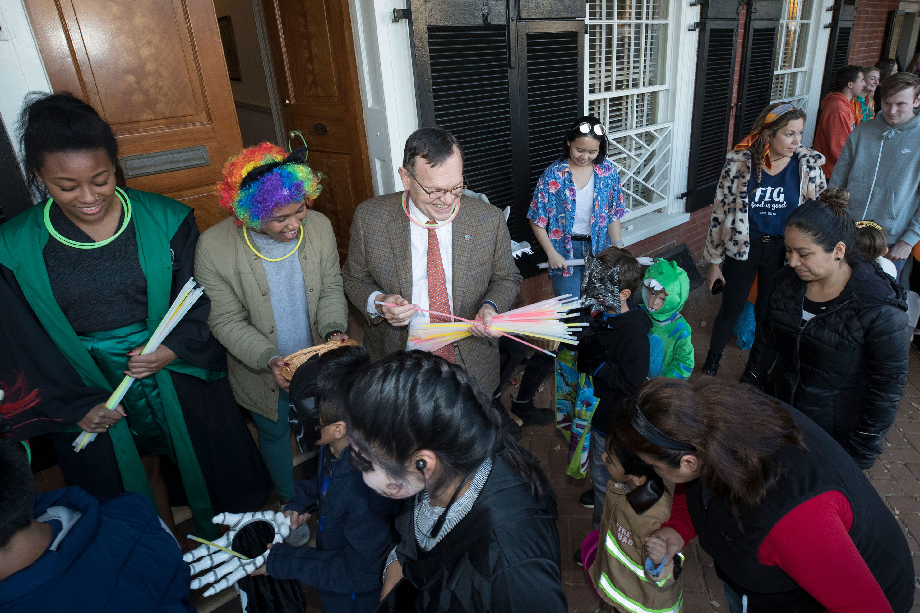 UVA professors handing out glow sticks to children trick or treating