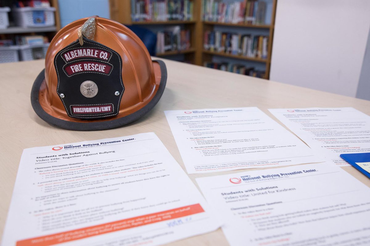 Albermarle County Fire Rescue helmet on a table with papers