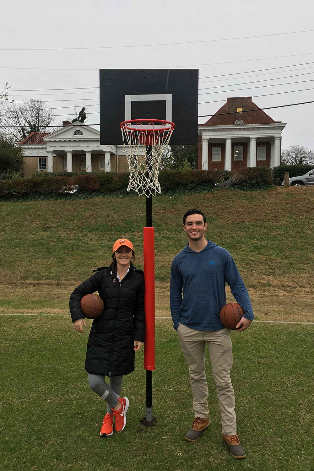f Molly Shields, left, and Tim Shields hold basketballs while standing on an outdoor basketball court