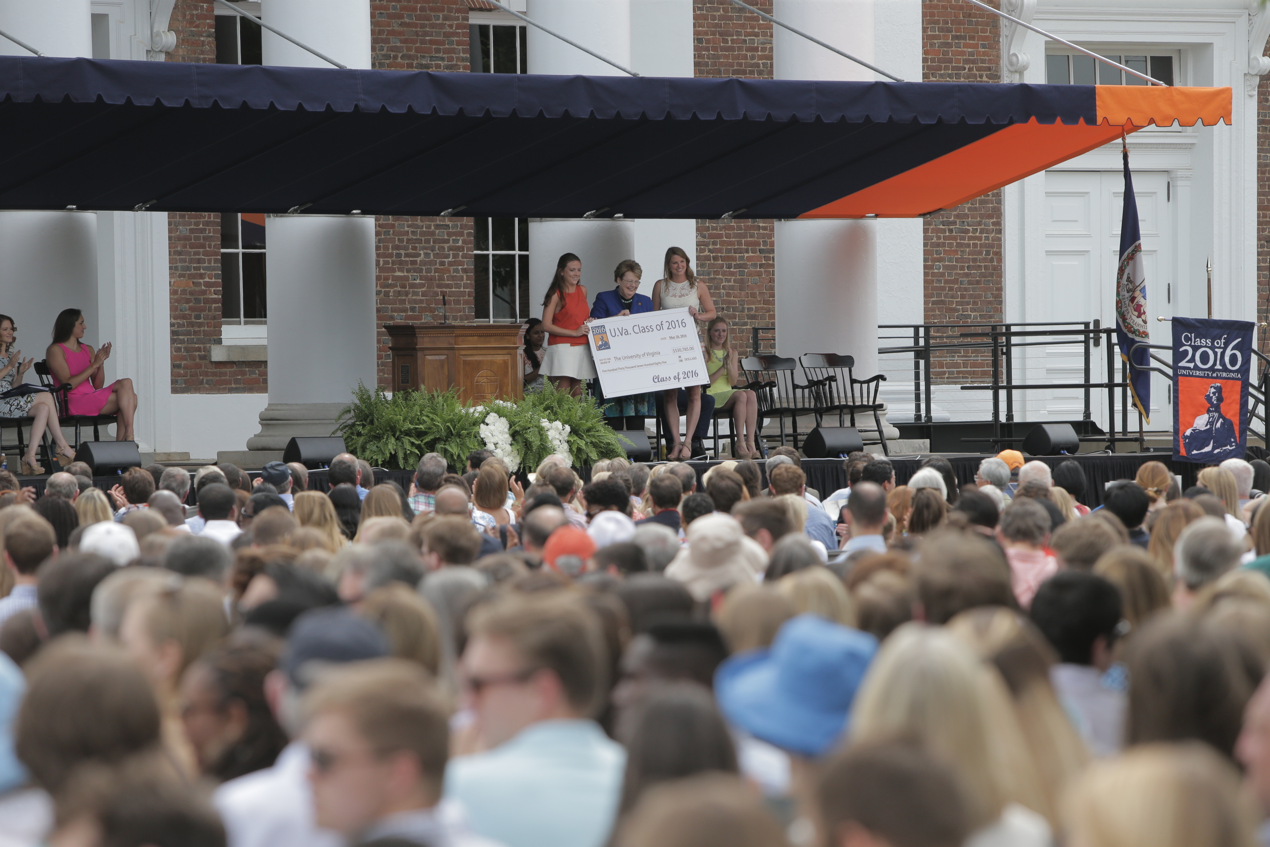 Two students stand with president Sullivan presenting a check from the class of 2016