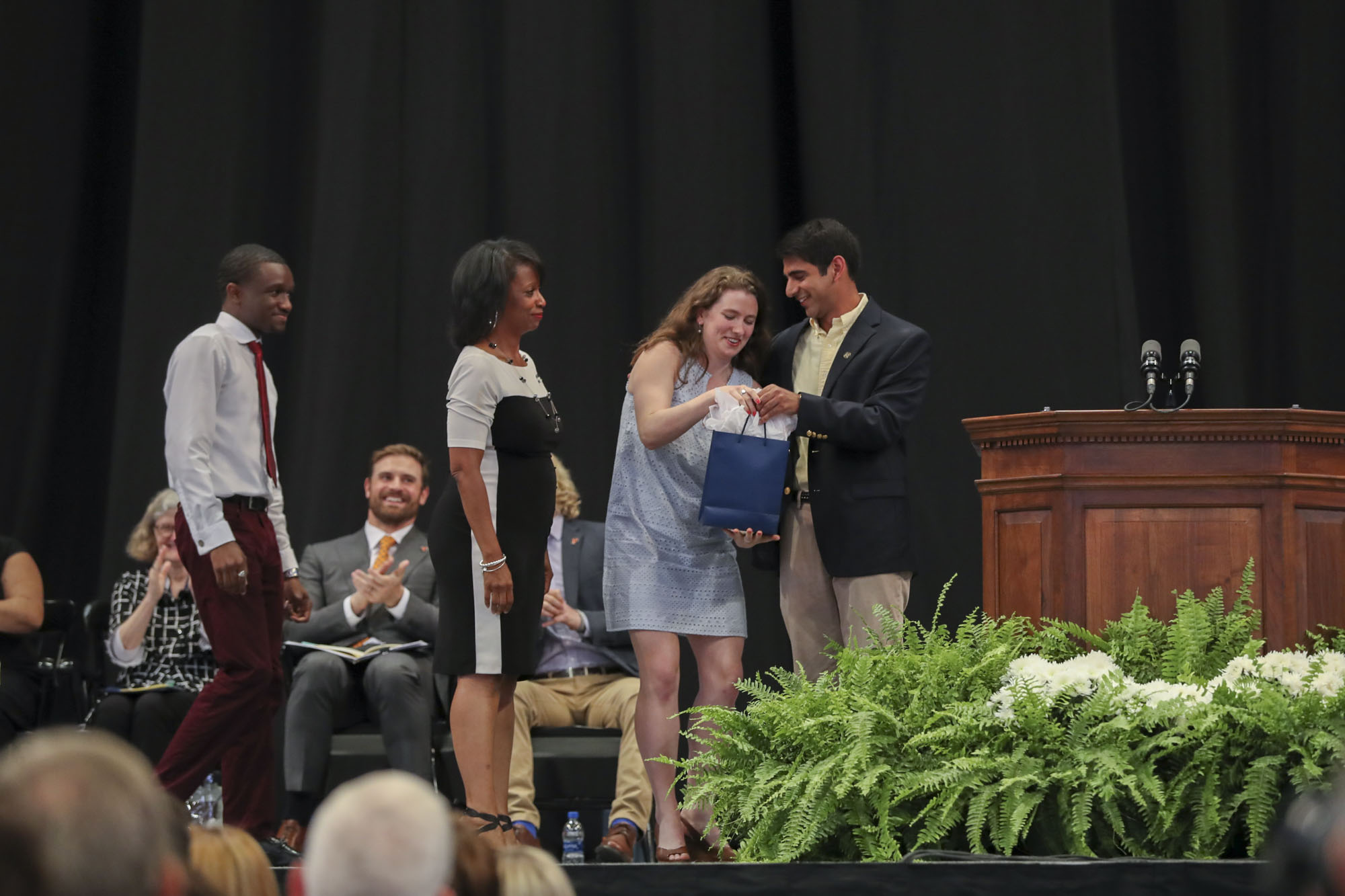 Rohan Kumar, right, Tyler Ambrose, Maeve Curtin, and Tabitha Enoch stand on stage together