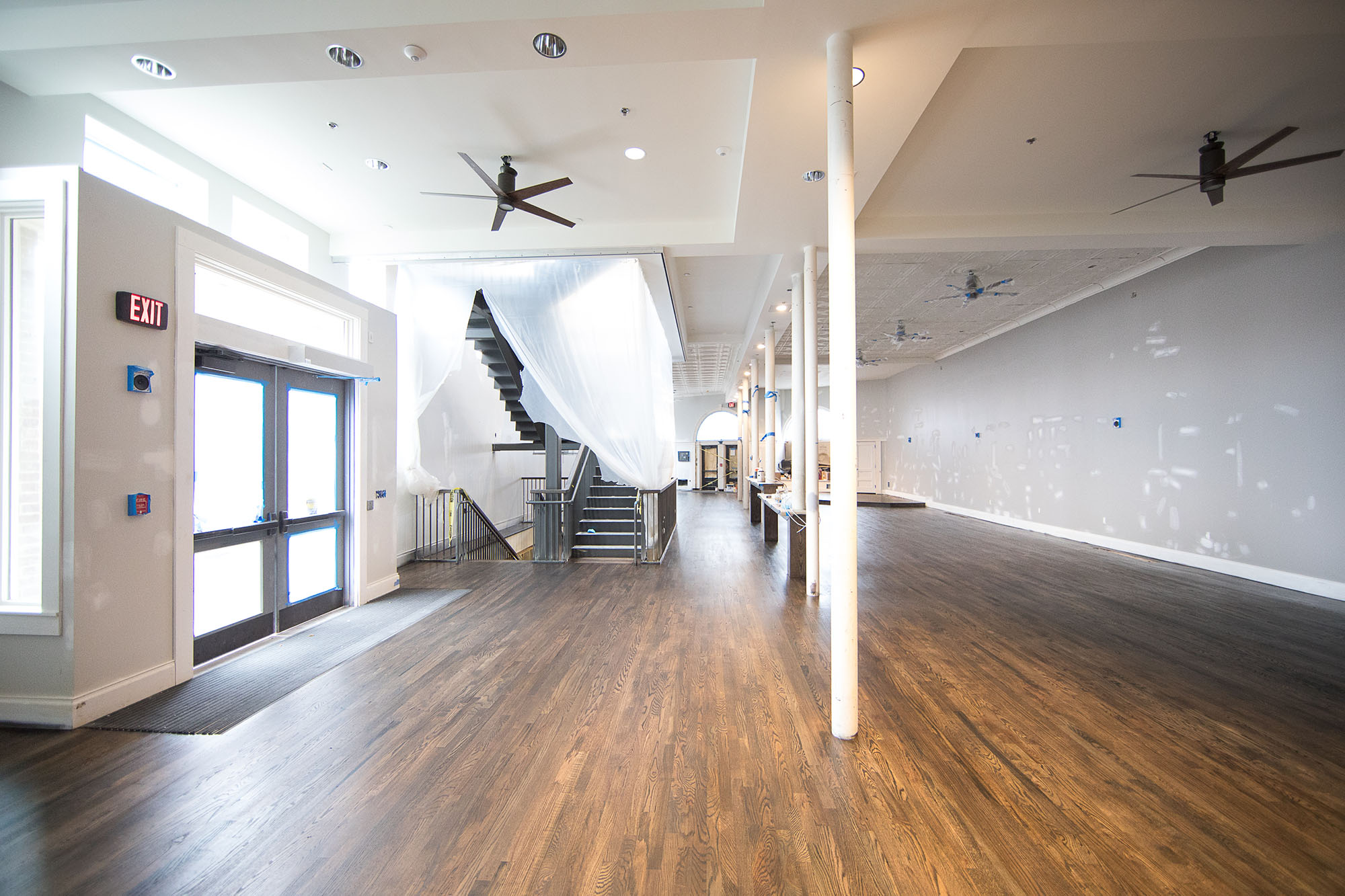  An early March view of the first floor, looking toward University Avenue, shows features such as the spiral staircase and preserved tin ceiling.