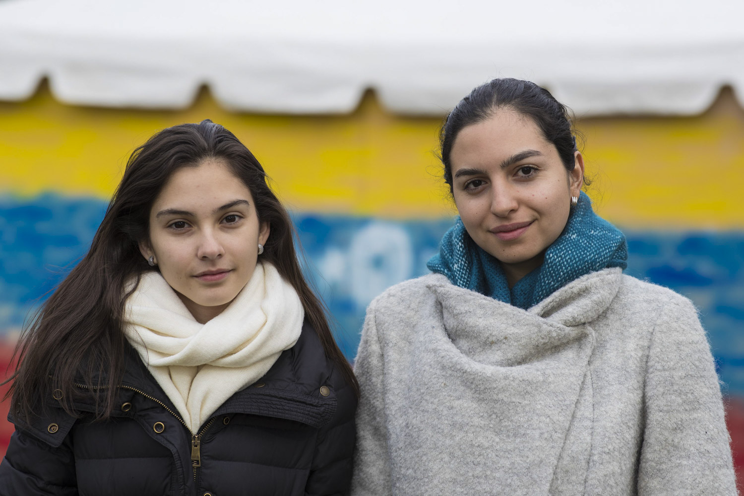 Maria Elena Granera, left, and Gabriela Corredor right, stand together in front of a Venezuelan building