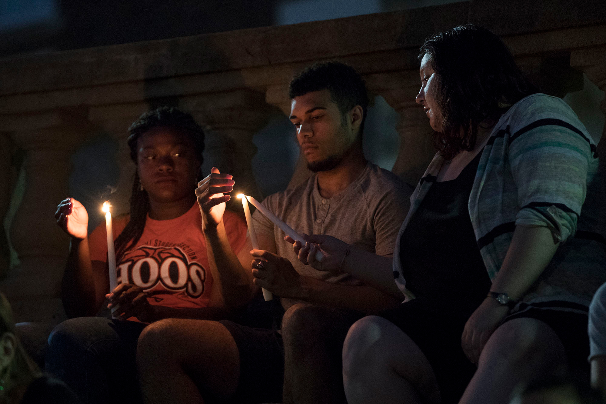Students lighting candles for a vigil
