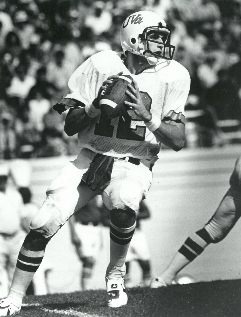 black and white photo of Schuchts in football uniform preparing to throw the ball
