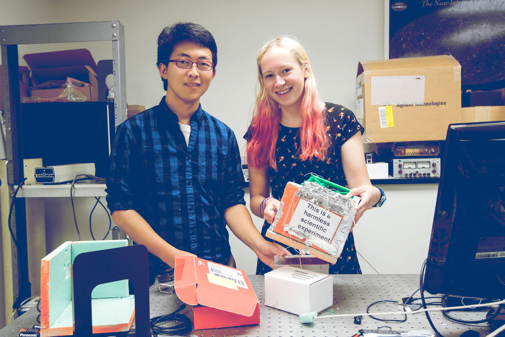 HeeSeok Joo, left, and Chloe Downs worked with physics student Nina Mazzarelli to design, build and fly an astronomy-related payload on a weather balloon. (Photo by Dan Addison, University Communications)