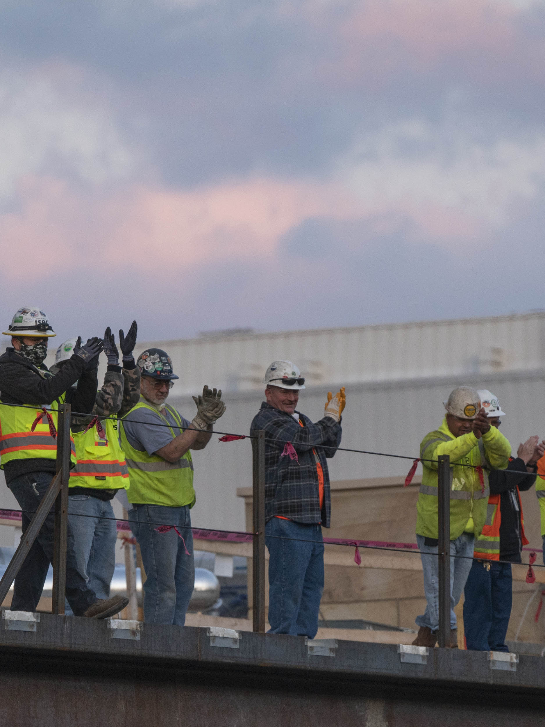 Close up of construction workers clapping for the healthcare workers