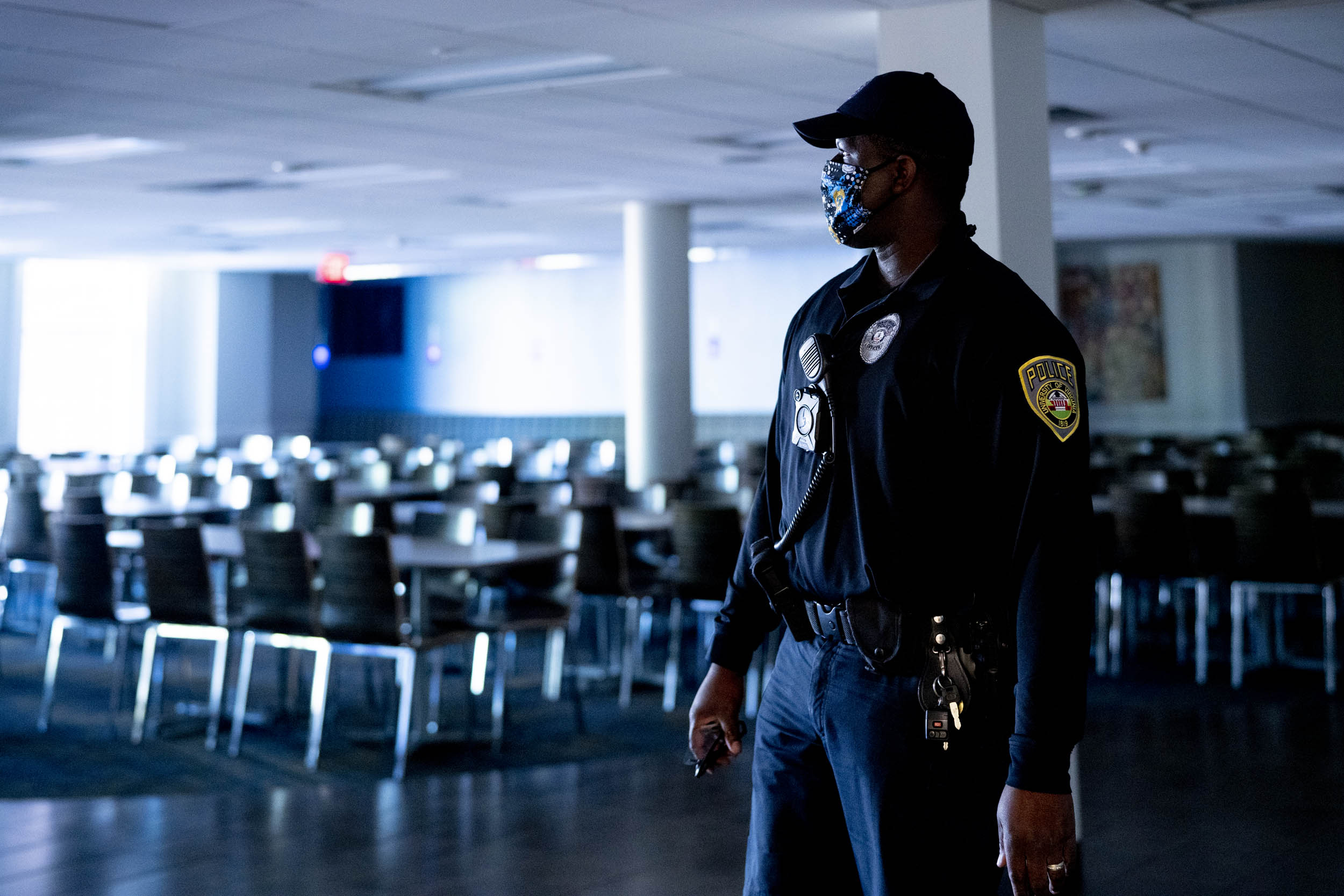 Police Officer walking through an empty UVA Building